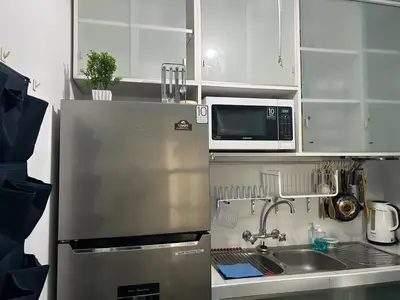 a kitchen with a stainless steel refrigerator and a microwave at Flat between Barranco, Miraflores & Surco in Lima