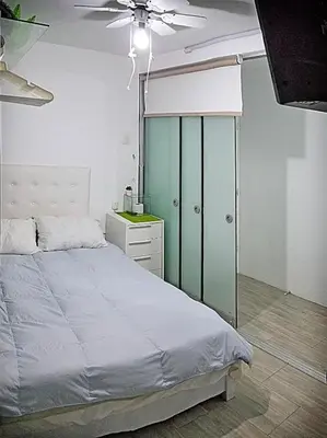 a bedroom with a bed and a ceiling fan at Flat between Barranco, Miraflores & Surco in Lima
