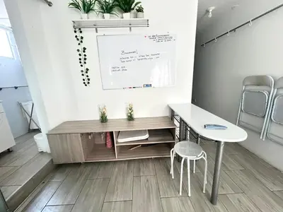 a room with a table and chairs and a whiteboard at Flat between Barranco, Miraflores & Surco in Lima