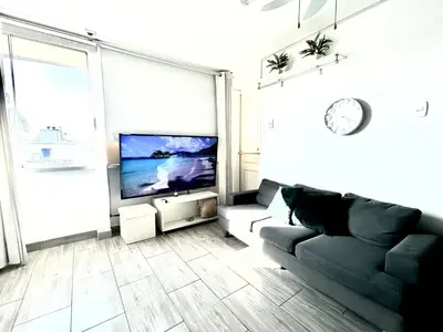 a living room with a couch and a flat screen tv at Flat between Barranco, Miraflores & Surco in Lima