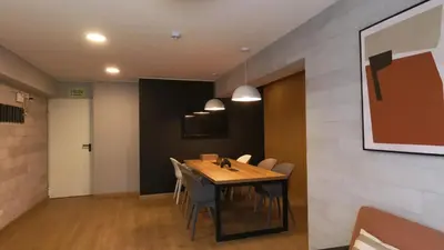 a dining room with a wooden table and chairs at Eurocasas Villa Velarde in Lima