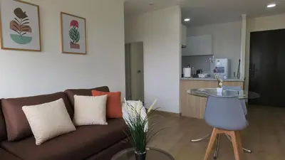 a living room with a brown couch and a table at Eurocasas Villa Velarde in Lima