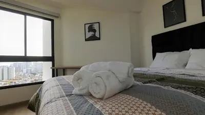 a bedroom with a bed with a towel animal on it at Eurocasas Villa Velarde in Lima