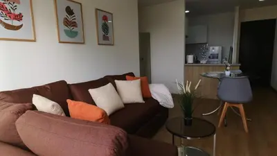a living room with a brown couch and a table at Eurocasas Villa Velarde in Lima