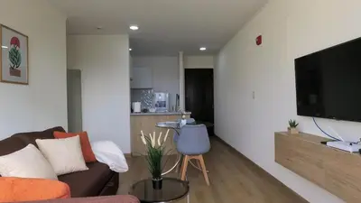 a living room with a couch and a flat screen tv at Eurocasas Villa Velarde in Lima