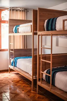 a room with bunk beds in a hostel at Casa Andora in Machu Picchu