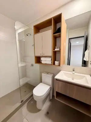 a white bathroom with a toilet and a sink at Departamento Style in Lima