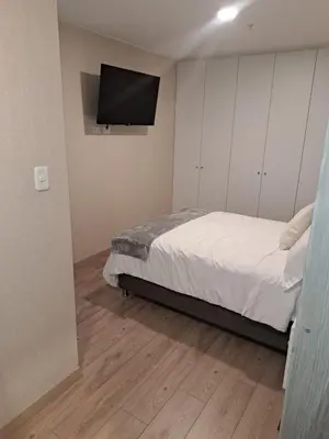 a bedroom with a bed and a flat screen tv at Modern apartment with great view in Lima in Lima