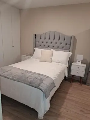 a bedroom with a large bed with a large headboard at Modern apartment with great view in Lima in Lima