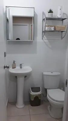 a bathroom with a sink and a toilet and a mirror at Modern apartment with great view in Lima in Lima