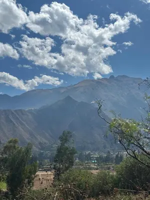 a view of a mountain range with clouds in the sky at Casa Divina Medicina in Urubamba
