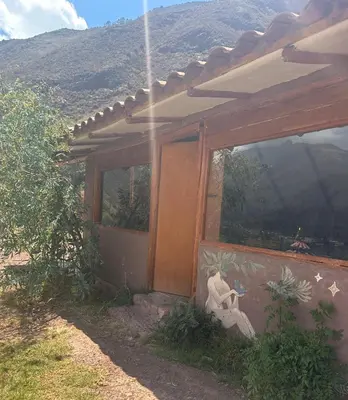 a house with a painting on the side of it at Casa Divina Medicina in Urubamba