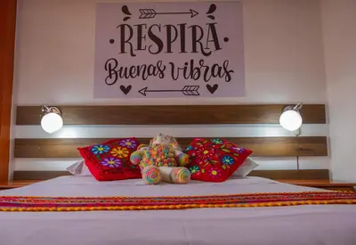a bed with two stuffed animals sitting on top of it at Mirador All Sur Cusco in Cusco