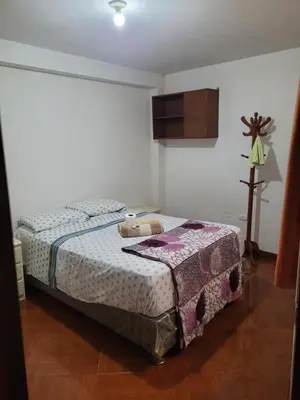 a bedroom with a bed with a teddy bear on it at Habitación privada cerca del aeropuerto in Lima