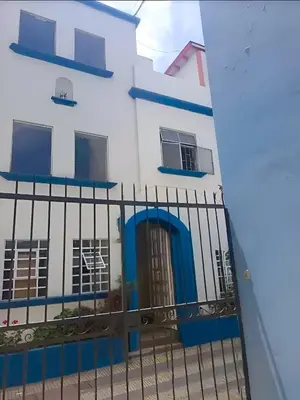 a building with a blue door and a fence at Comfy Rooms in a Cozy House - Miraflores in Lima