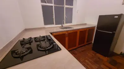 a kitchen with a black stove and a refrigerator at Comfy Rooms in a Cozy House - Miraflores in Lima
