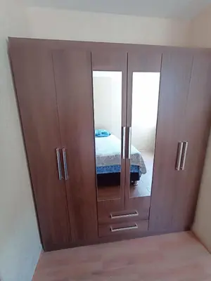 a large wooden cabinet with a mirror in a room at Departamento amoblado y Estacionamiento Gratis in Lima