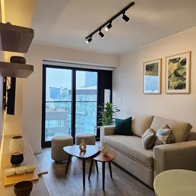 a living room with a couch and a table at Modern Brand New Apartment in Miraflores in Lima