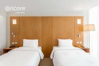 two beds sitting next to each other in a room at Ramada Encore by Wyndham Lima San Isidro in Lima
