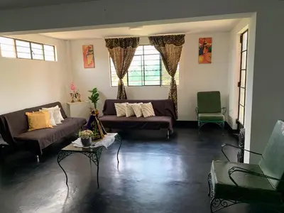 a living room with two couches and a table at HOSPEDAJE don VICTOR