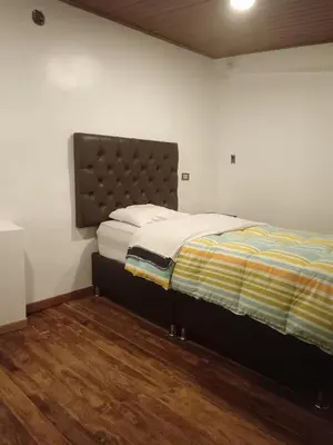 a bedroom with a bed and a wooden floor at Redy's House in Cusco