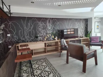 a living room with a desk and a tv at Departamento Osma in Lima