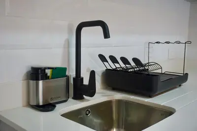 a kitchen counter with a sink and a mixer and a kitchen sink at Great New Studio in Barranco in Lima