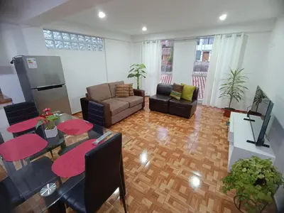 a living room with a couch and a table at Apartamento en Cusco IV in Cusco