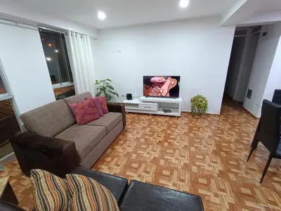 a living room with a couch and a flat screen tv at Apartamento en Cusco IV in Cusco