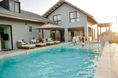a family playing in the swimming pool of a house at Casa Campo-Playa Sand in My Shoes in Chincha