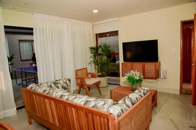 a living room with a couch and a tv at Casa Campo-Playa Sand in My Shoes in Chincha