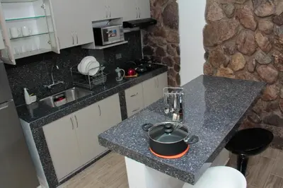 a kitchen with a counter top with a pot on it at Valle Sagrado Mágico in Urubamba