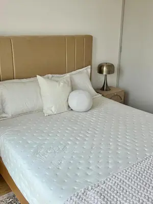 a white bed with white pillows at Great 1BR in San Isidro in Lima