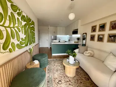 a living room with a couch and a kitchen at Great 1BR in San Isidro in Lima