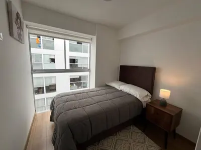 a small bedroom with a bed and a window at Entire apartment minutes from Miraflores in Lima