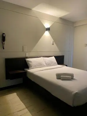 a bedroom with a bed with a light on it at Hotel Naciones Unidas in Lima