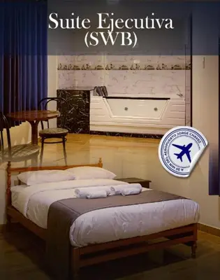 a bedroom with a bed with a sign on the wall at Hotel Naciones Unidas in Lima
