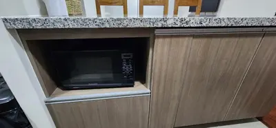a microwave oven in a cabinet in a kitchen at Modern suite in San Miguel -Costa 21 in Lima