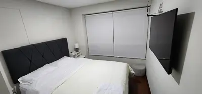 a bedroom with a bed and a large window at Modern suite in San Miguel -Costa 21 in Lima