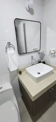a bathroom with a white sink and a mirror at Modern suite in San Miguel -Costa 21 in Lima