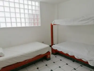 two bunk beds in a room with a window at Casa de Playa en Lobos in Cerro Azul