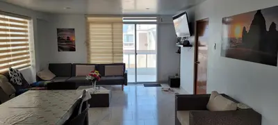 a living room with a couch and a table at Bravos Hospedaje Punta Negra in Punta Negra