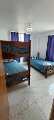 two bunk beds in a room with a tile floor at Bravos Hospedaje Punta Negra in Punta Negra