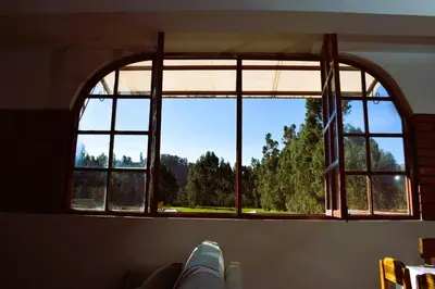 a window in a room with a view of trees at Fundo Venegas & Montoya in Jauja