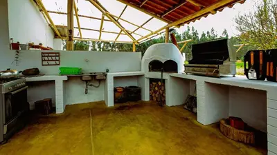an outdoor kitchen with a stove and an oven at Fundo Venegas & Montoya in Jauja