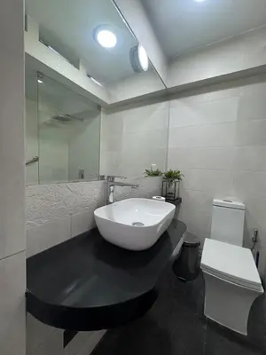 a bathroom with a white sink and a toilet at Centrally located and comfortable duplex in Miraflores - Libertad1BR in Lima