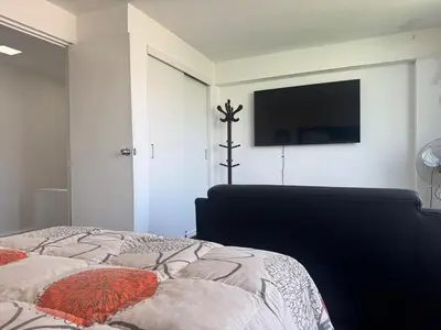 a bedroom with a bed and a flat screen tv at Centrally located and comfortable duplex in Miraflores - Libertad1BR in Lima