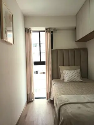 a bedroom with a bed and a large window at Katty's apartment - Santa Beatriz in Lima