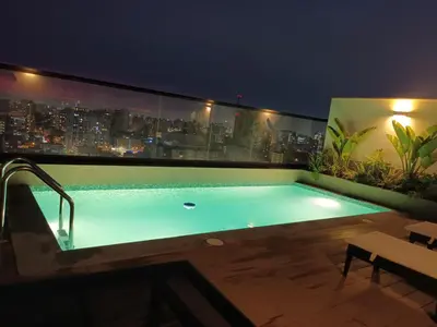 a swimming pool on the roof of a building at Katty's apartment - Santa Beatriz in Lima
