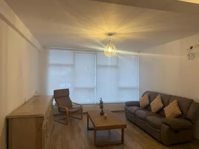 a living room with a couch and a table at Welcoming apartment in Lima